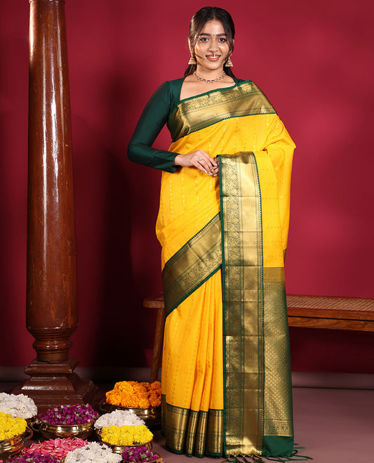 Yellow Budget Silk Saree, Richly Detailed with Zari Muthu, and Zari Buttas on Its Body, Complemented by a Contrast Traditional Zari Design Border of Peacock Designs, Gleaming Jaal Pallu, and Paired with a Contrast Blouse
