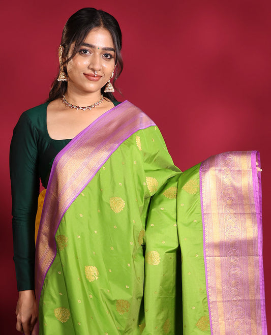 Parrot Green Budget Silk Saree, Embellished with Zari Buttas on Its Body, Complemented by a Contrast Traditional Zari Design Border, Grandly Decked Up Pallu, and Paired with a Contrast Blouse