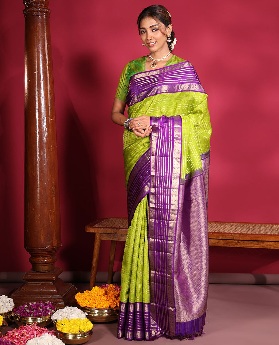 Green Vasundhara Silk Saree, Spotlighted with Zari Checked Design All Over Its Body, Complemented by a Contrast Varisai Pettu Border of Muthu, Poun, and Chakram Designs, Grandly Embellished Pallu of Jaal Designs, and Paired with a Contrast Blouse