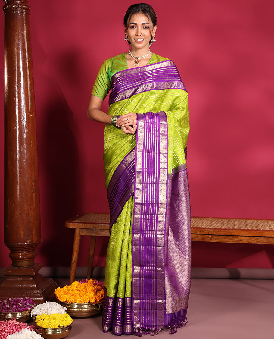 Green Vasundhara Silk Saree, Spotlighted with Zari Checked Design All Over Its Body, Complemented by a Contrast Varisai Pettu Border of Muthu, Poun, and Chakram Designs, Grandly Embellished Pallu of Jaal Designs, and Paired with a Contrast Blouse