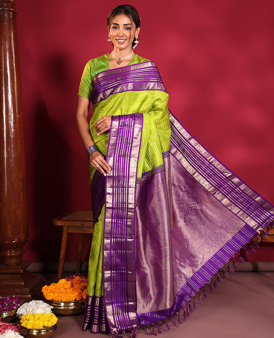 Green Vasundhara Silk Saree, Spotlighted with Zari Checked Design All Over Its Body, Complemented by a Contrast Varisai Pettu Border of Muthu, Poun, and Chakram Designs, Grandly Embellished Pallu of Jaal Designs, and Paired with a Contrast Blouse