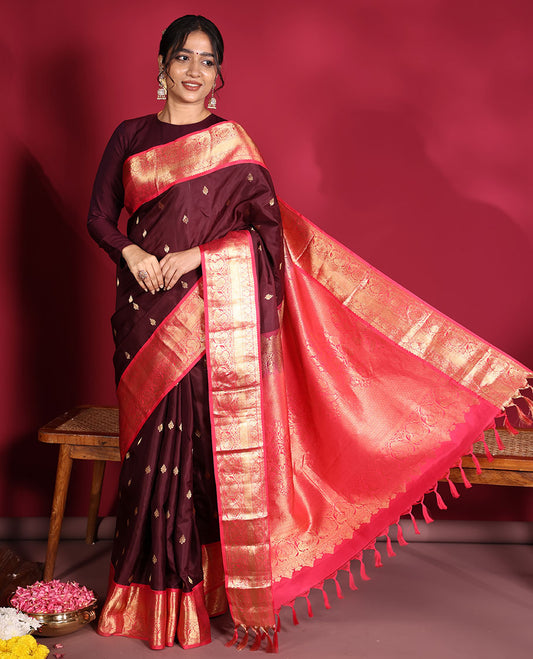 Brown Vasundhara Silk Saree, Decorated with Zari Buttas on Its Body, Complemented by a Contrast Traditional Zari Border of Mayil Designs, Grand Pallu Depicts Jaal and Floral Designs, and Paired with a Contrasting Blouse
