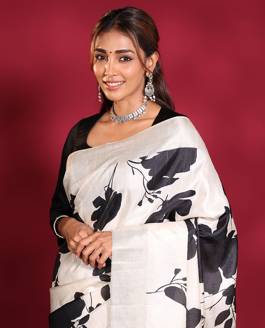 Cream Fancy Tussar Saree, Artfully Detailed with Silhouette-Style Floral Motifs Printed on Its Body, Subtle Zari-Textured Border, Pallu Pictures the Same Floral Print, and Paired with a Matching Blouse
