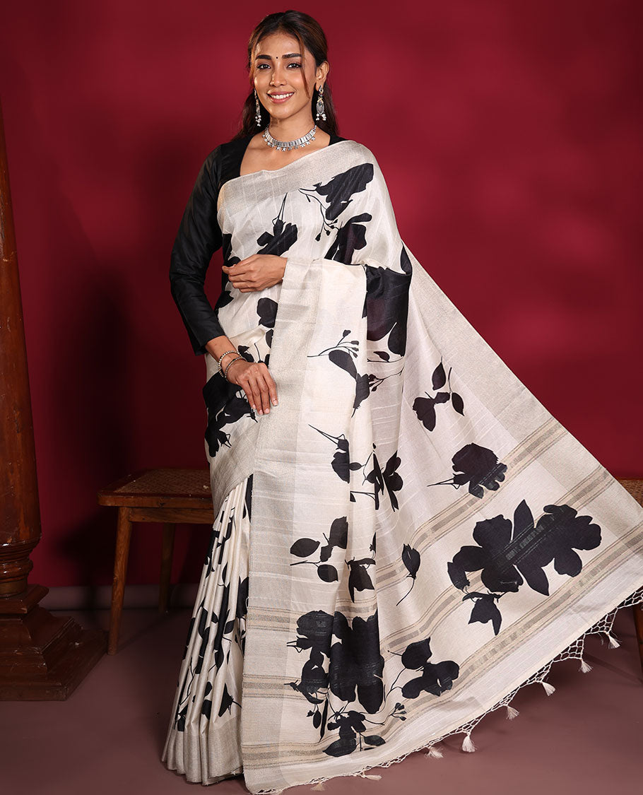 Cream Fancy Tussar Saree, Artfully Detailed with Silhouette-Style Floral Motifs Printed on Its Body, Subtle Zari-Textured Border, Pallu Pictures the Same Floral Print, and Paired with a Matching Blouse