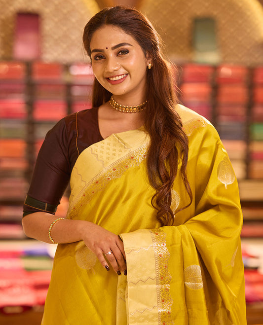 Mustard unblossomed flower-shape zari buttas raw mango silksaree,satin embossed border of meenakari zari floral vine & scallop jacquard pallu