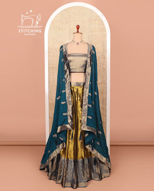 Gold-peacock blue zari buttas half-saree with contrast intricate motifs woven bordered skirt, brocade blouse, and a zari design dhavani