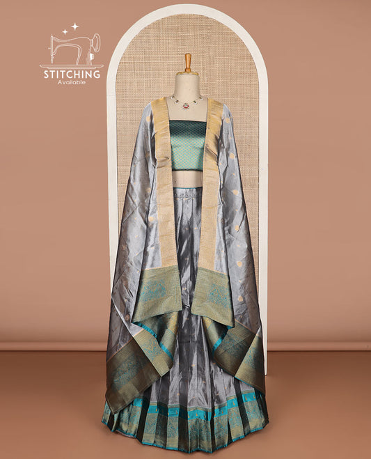 Grey buttas tissue half saree with contrast zari design border, checked design blouse & floral design dhavani