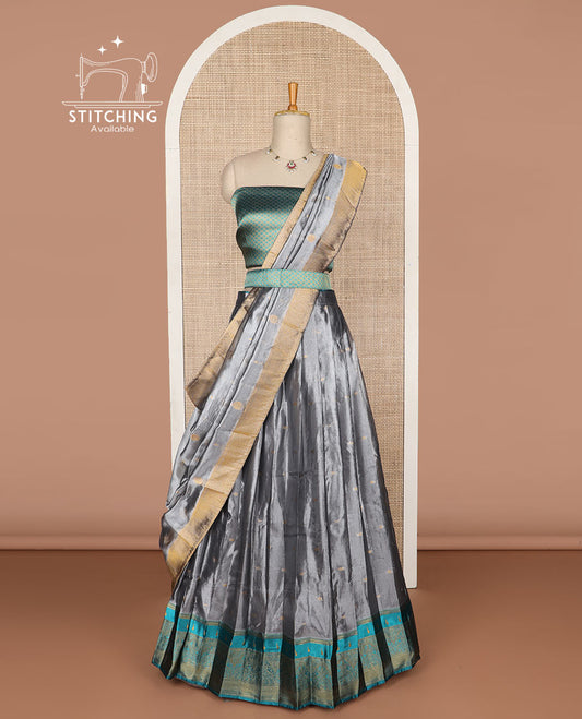Grey buttas tissue half saree with contrast zari design border, checked design blouse & floral design dhavani