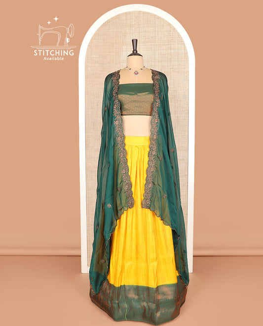 Yellow art silk half-saree, checked with contrast traditional zari bordered skirt, jacquard blouse, and scallop embroidered dhavani