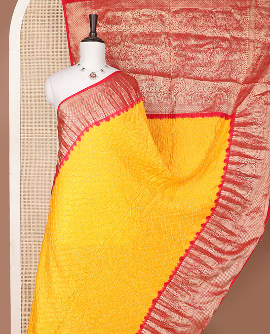 Orange bandhani silk saree with contrast zari design border & floral design pallu