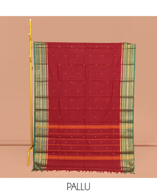 Maroon Chettinad Cotton Saree, Adorned with Buttas All Over Its Body, Complemented by Contrast Traditional Zari Design Border, Pallu of Stripes and Buttas, and Paired with a Matching Blouse