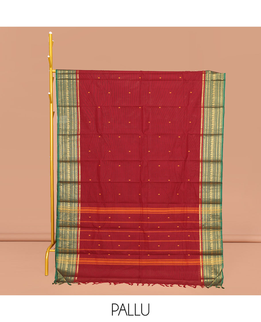 Maroon Chettinad Cotton Saree, Adorned with Buttas All Over Its Body, Complemented by Contrast Traditional Zari Design Border, Pallu of Stripes and Buttas, and Paired with a Matching Blouse