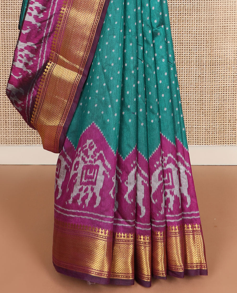 Green buttas semi-banaras patola silk saree, contrast elephant motifs border of traditional zari designs, and pallu of elephant motifs