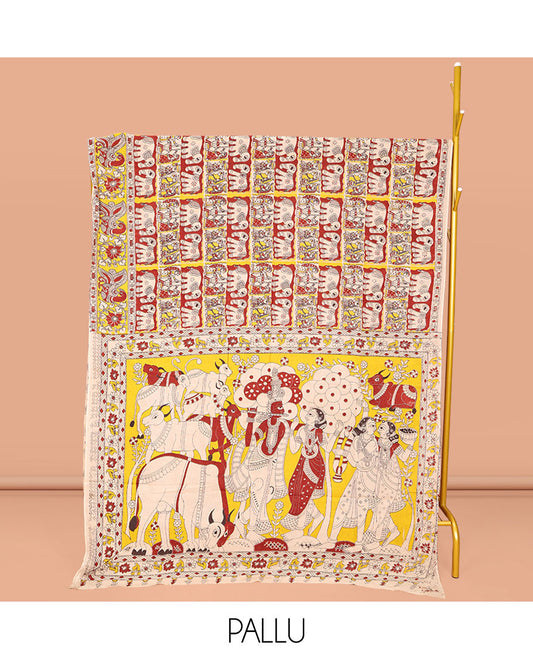 Yellow Machine-Printed Kalamkari Cotton Saree, Adorned with Elephant and Human Figurine Enclosed Checks on Its Body, Complemented by a Contrast Peacock Printed Border, Pallu of Radha Krishnan Motifs Print, and Paired with a Printed Blouse
