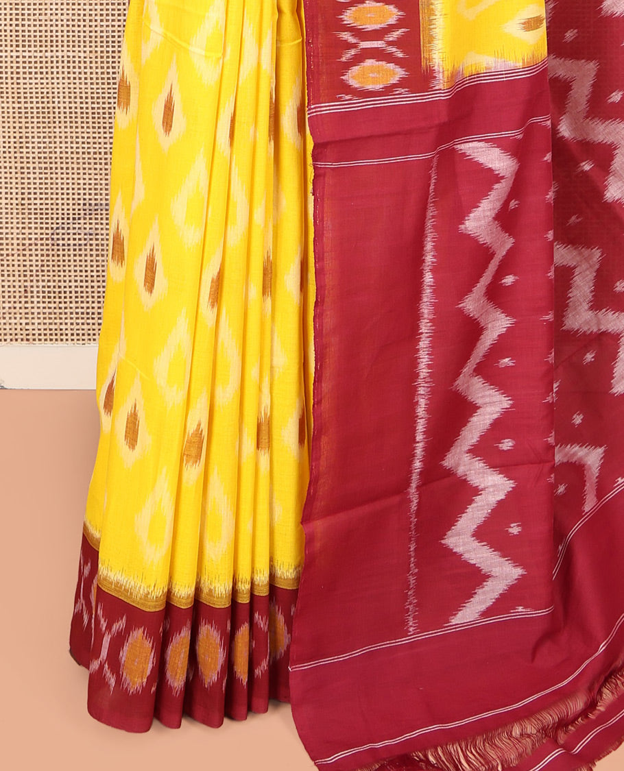 Yellow Ikkat Cotton Saree, Adorned with Ikkat Buttas All Over Its Body, Complemented by a Contrast Border of Ikkat Buttas, Chevron Striped Pallu, and Has No Blouse