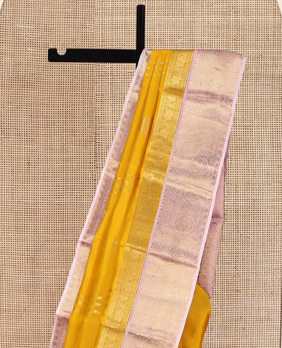 Mustard Yellow-Beach Pink Vasundhara Silk Saree, Richly Detailed with Zari Buttas, Complemented by Contrast Border of Kamalam, Muthu, Cross Kamalam, Rudraksham, and Thilakam Design, Pallu Steeped with Thilakam Designs, and Paired with a Contrast Blouse