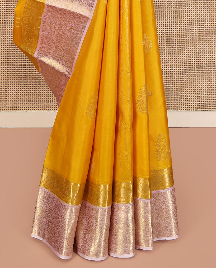 Mustard Yellow-Beach Pink Vasundhara Silk Saree, Richly Detailed with Zari Buttas, Complemented by Contrast Border of Kamalam, Muthu, Cross Kamalam, Rudraksham, and Thilakam Design, Pallu Steeped with Thilakam Designs, and Paired with a Contrast Blouse