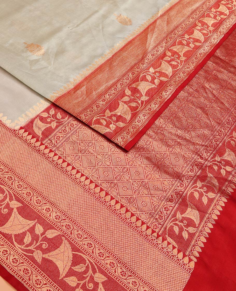 Grey Raw Mango Silk Saree Adorned with Buttas, Complemented by a Contrast Traditional Zari-Designed Border, Featuring a Zari-Elevated Jaal-Designed Pallu, Paired with a Contrast Blouse