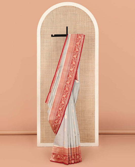 Grey Raw Mango Silk Saree Adorned with Buttas, Complemented by a Contrast Traditional Zari-Designed Border, Featuring a Zari-Elevated Jaal-Designed Pallu, Paired with a Contrast Blouse