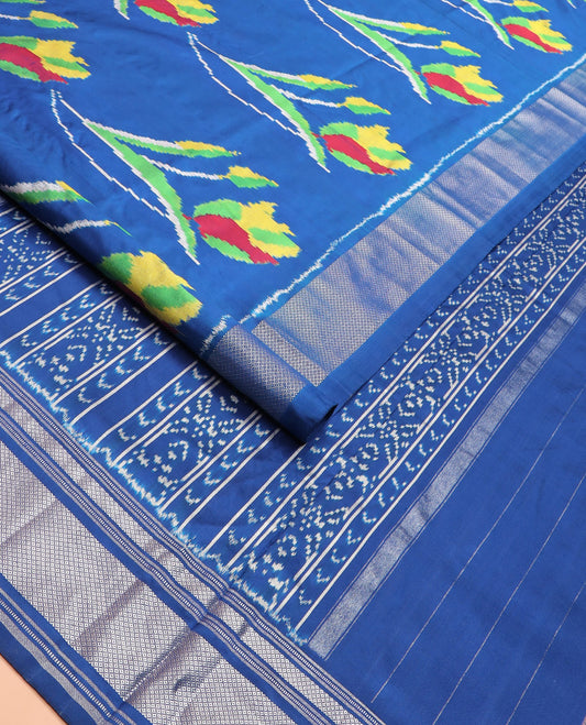 Blue Ikkat Silk Saree Colourfully Woven in Floral Buttas Across the Body, Featuring a Zari Border, a Pallu Adorned with Ikkat Weave, and Paired with a Matching Blouse