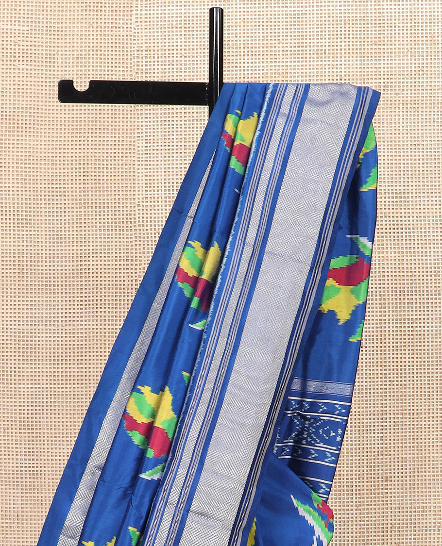 Blue Ikkat Silk Saree Colourfully Woven in Floral Buttas Across the Body, Featuring a Zari Border, a Pallu Adorned with Ikkat Weave, and Paired with a Matching Blouse