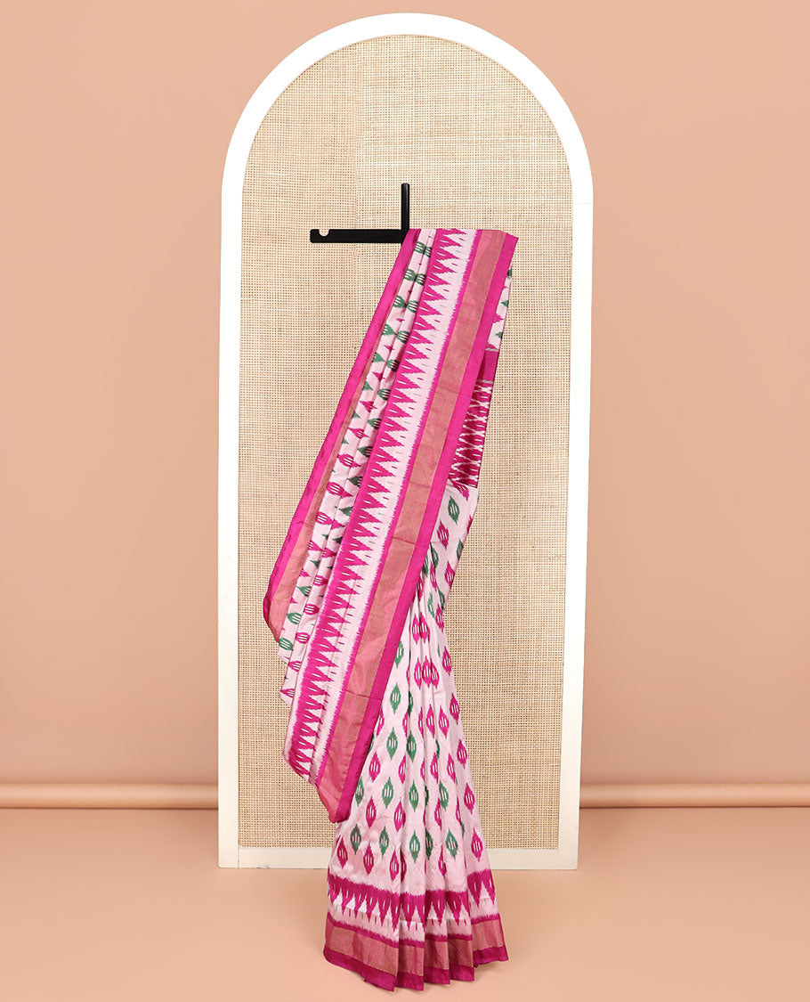 Pink Ikkat Silk Saree Highlighted with Diamond-Shaped Ikkat Buttas, Featuring a Contrast Ikkat Temple Border and a Pallu Showcasing an Ikkat-Textured Jaal Design, Paired with a Contrast Blouse