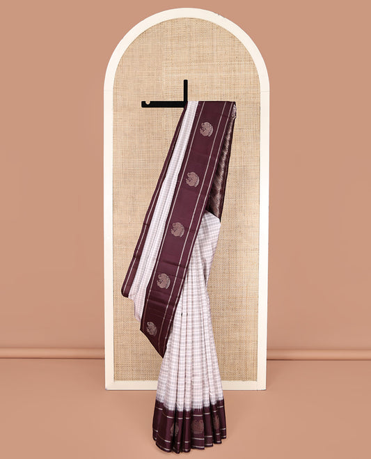 Off-white Kanchipuram Silk Saree, Subtly Sparkled with Checked Design On Its Body, Complemented by Contrast Border of Banaras and Annam Designs, Pallu of Diagonal Rekku Designs, and Paired with a Contrast Blouse