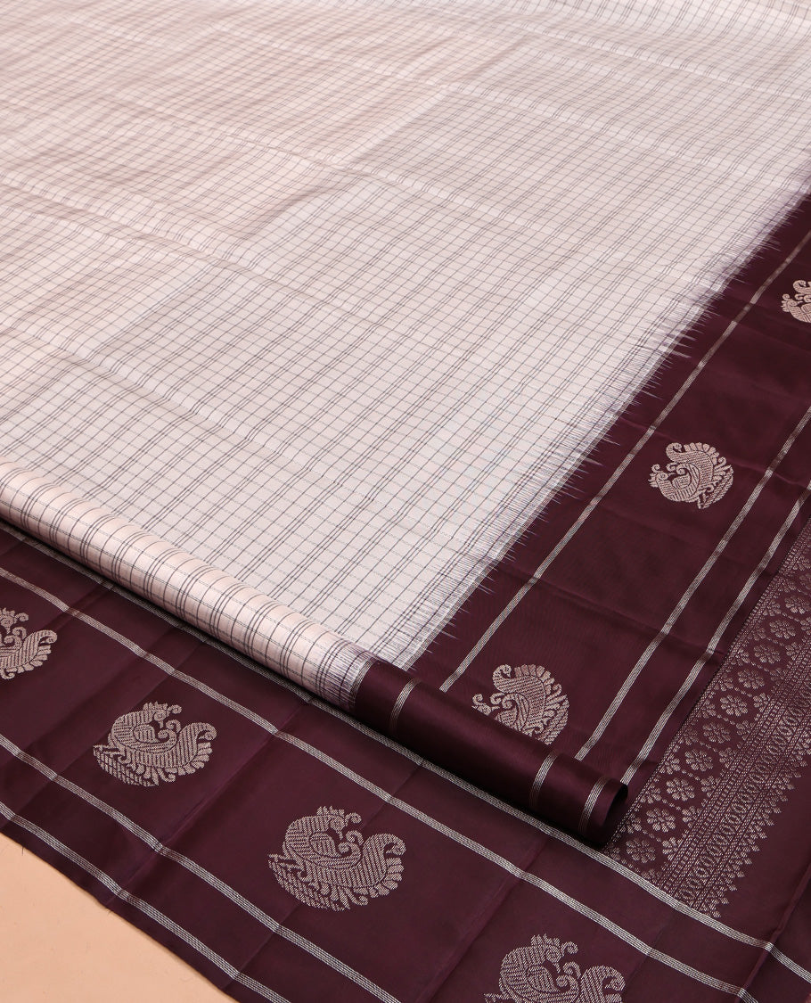 Off-white Kanchipuram Silk Saree, Subtly Sparkled with Checked Design On Its Body, Complemented by Contrast Border of Banaras and Annam Designs, Pallu of Diagonal Rekku Designs, and Paired with a Contrast Blouse
