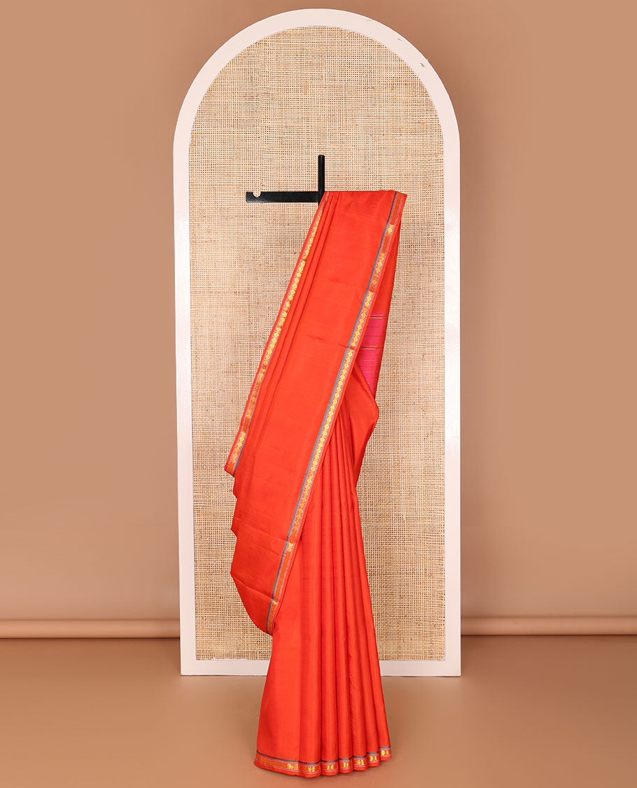 Red kancheepuram silk saree with self border of thilakam mokku, paun design & striped pallu