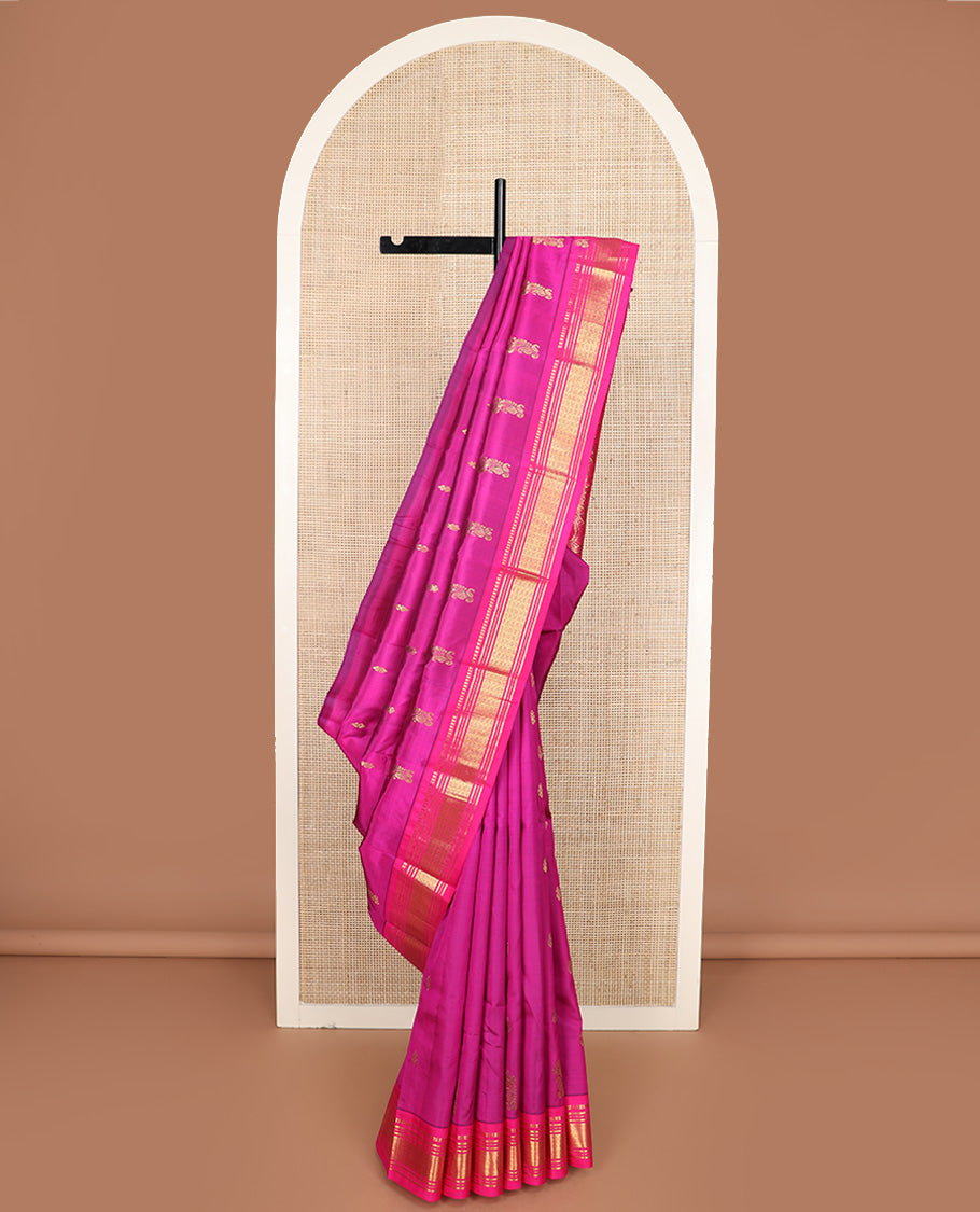 Pink zari buttas Kanchipuram silk saree, contrast one-sided border of paneer sombu, banaras, muthu, and jaal design, and manga design pallu