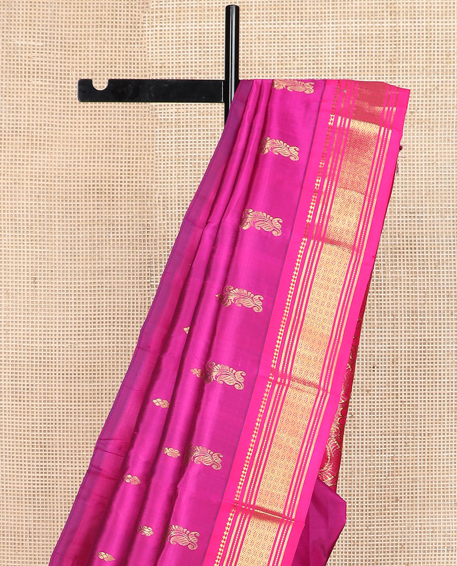 Pink zari buttas Kanchipuram silk saree, contrast one-sided border of paneer sombu, banaras, muthu, and jaal design, and manga design pallu
