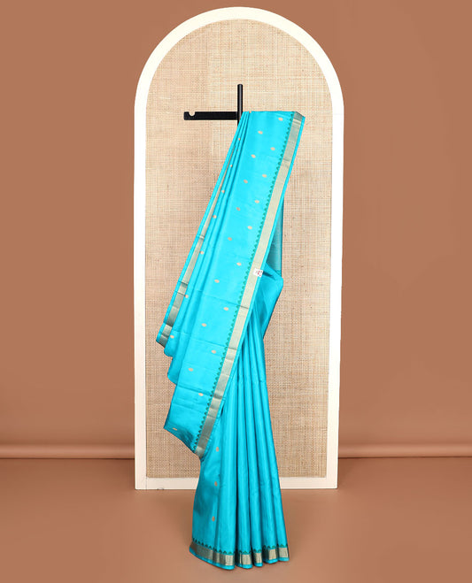 Blue buttas Kanchipuram silk saree, self-border of thazampoo rekku, and vanki designs, and pallu of thilakam mokku, manga mokku, and jaal designs