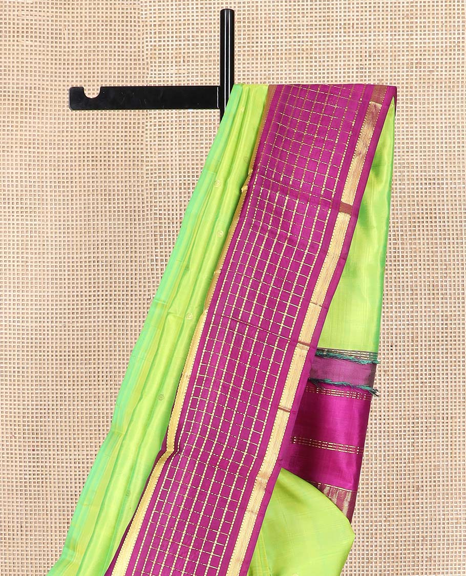 Green zari buttas Kanchipuram silk saree, contrast thazampoo rekku one-sided border of muthu, and muthu kattam designs, and pallu of pillaiyar mokku designs