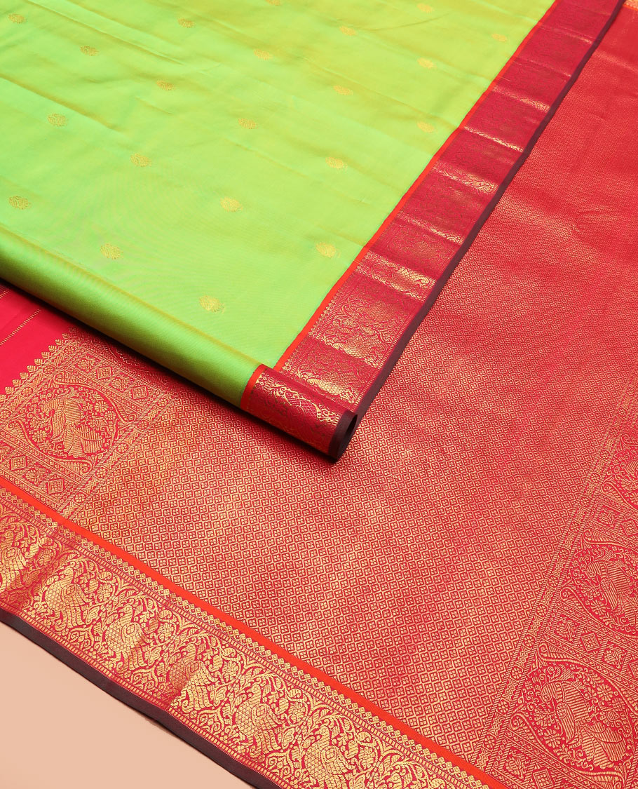Green zari buttas Kanchipuram silk saree, contrast korvai border of thilakam mokku, muthu, and mayil designs, and jaal pallu