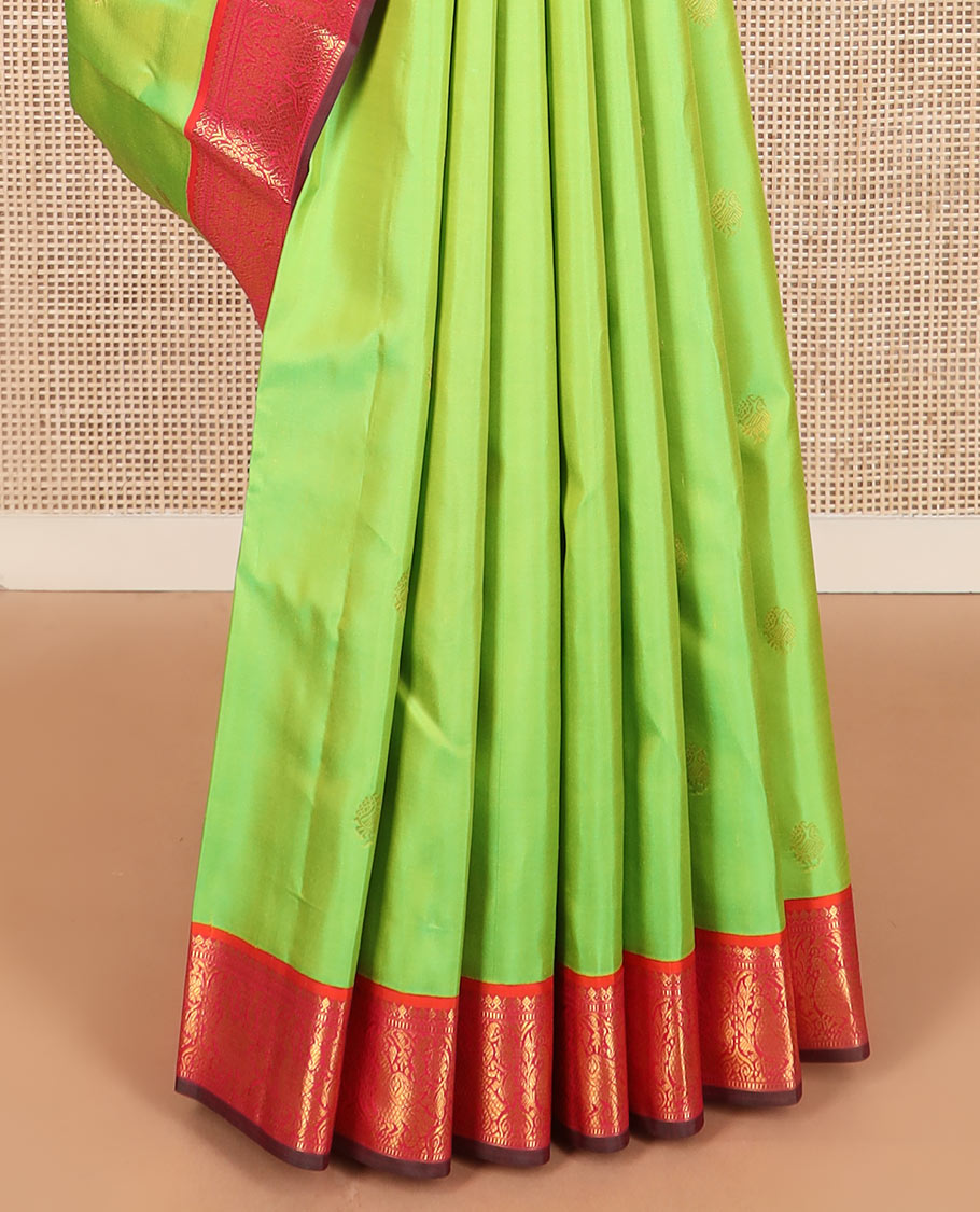 Green zari buttas Kanchipuram silk saree, contrast korvai border of thilakam mokku, muthu, and mayil designs, and jaal pallu