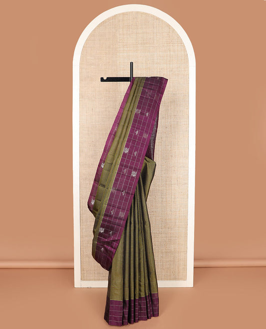 Green stripes and muthu striped Kanchipuram silk saree, contrast border of mayil and lotus butta enclosed checks, and intricate jaal pallu