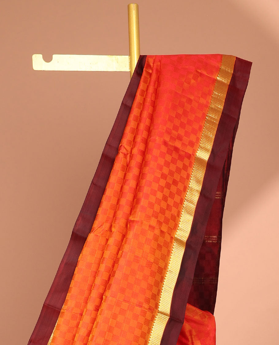 Orange checked kancheepuram silk saree with contrast temple border & checked design pallu