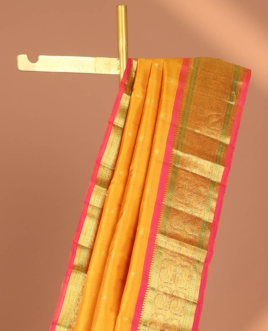 Orange leaf buttas kancheepuram silk saree with contrast border of sombu, paun, mayil design & zari design pallu