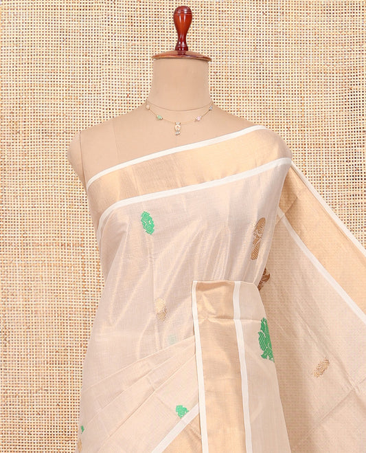Cream Kerala Cotton Saree, Adorned with Thread and Zari Buttas All Over Its Body, a Zari Bavanji Border, an Intricate Pallu, and Paired with a Matching Blouse