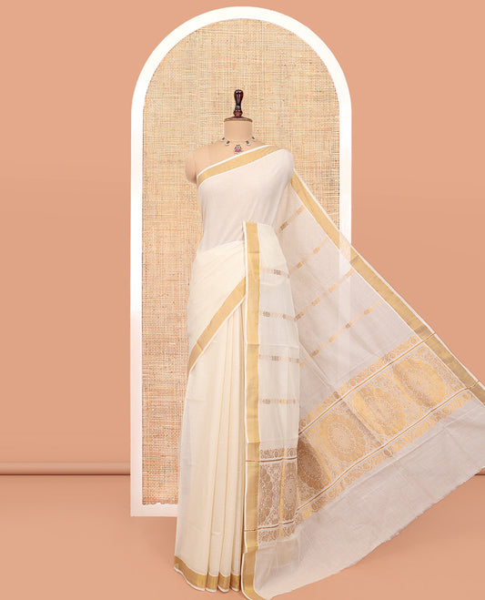Cream Kerala Cotton Saree, Decorated with Zari Stripes All Over Its Body, a Subtle Bavanji Border, Pallu Features Chakram Designs, and Is Paired with a Matching Blouse