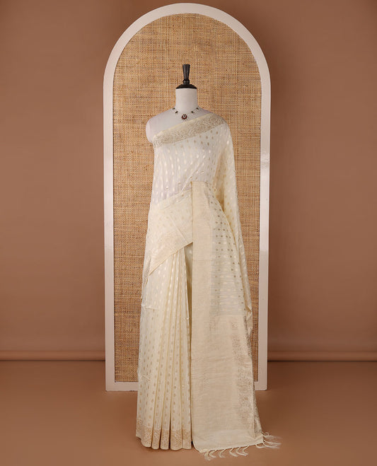 Cream banarasi jute saree with zari buttas, floral creeper zari border, floral jaal zari woven pallu & zari woven blouse
