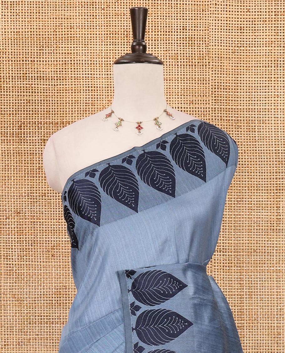 Grey plain jute cotton saree , contrast leaf thread butta border & lining seer pallu with tussels