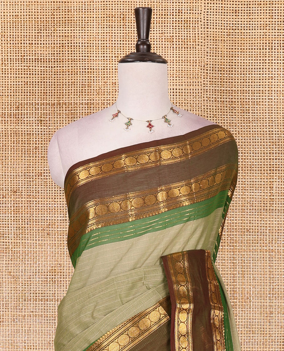 Green striped Chettinad cotton saree, contrast rettai rettu rudraksham motif zari border, striped pallu, and matching blouse