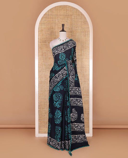 Navy blue-green batik floral printed soft cotton saree, batik printed pom-pom tasseled border, batik floral printed pallu, and a matching blouse