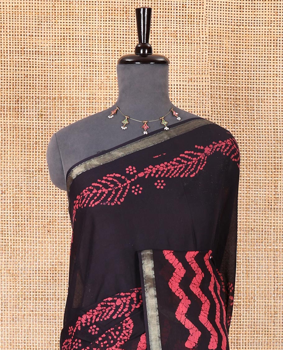 Ink blue wax batik-style zig-zag printed pure cotton saree, gold zari piping border, human figurines batik printed pallu, and a matching blouse