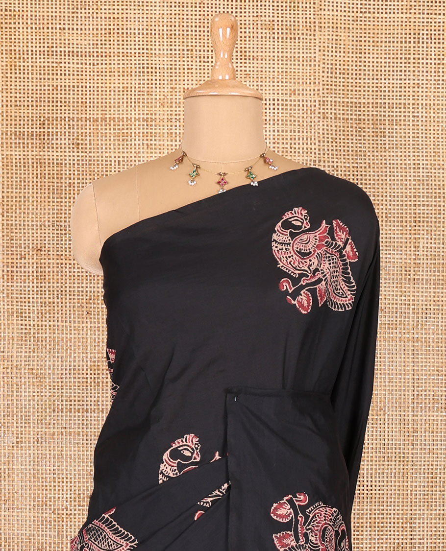Borderless black peacock motifs printed South cotton saree with a matching blouse, and a contrast floral motifs printed blouse