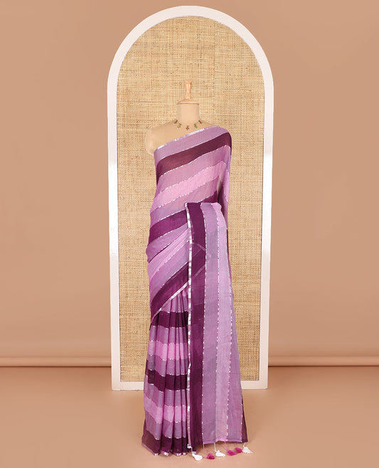 Magenta ombre-colored striped khadi mul cotton saree, zari piping border, striped pallu, and a matching striped blouse