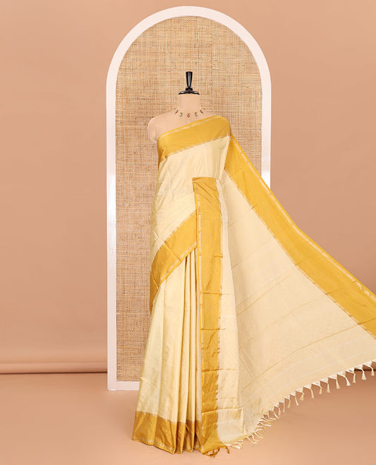Light yellow dobby style zari buttas semi-soft silk saree, contrast zari border, striped pallu, and a contrast plain blouse