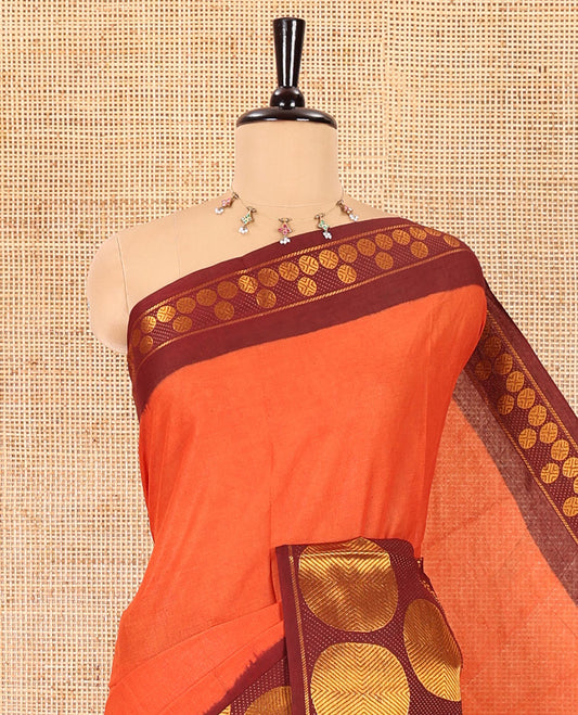 Rust orange plain sungudi cotton saree, contrast big rudraksham motifs woven border, striped pallu, and a contrast plain blouse