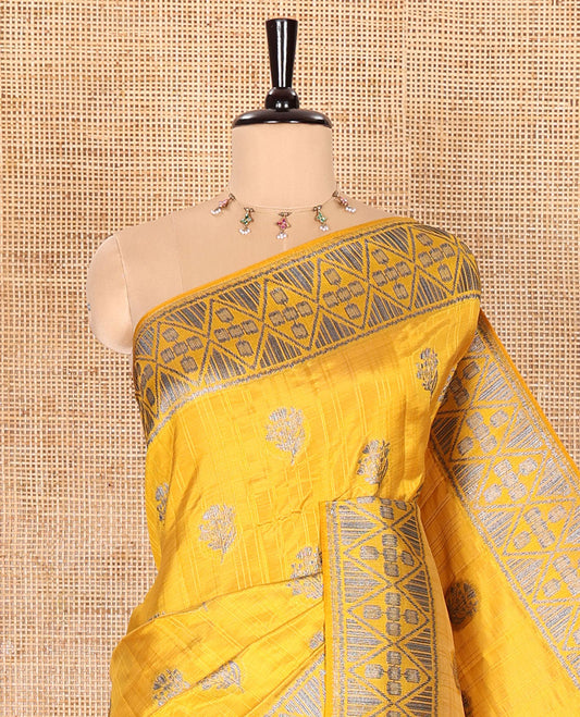 Mustard Semi-Tussar Saree Subtly Woven With Floral Zari Buttas, Featuring a Geometric-Patterned Zari Border, Adorned With a Butta-Enclosed Checked Pallu, and a Matching Blouse